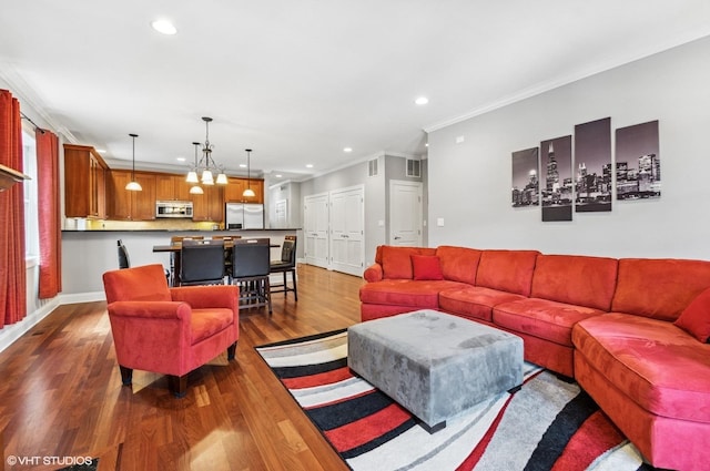 living room featuring dark wood finished floors, recessed lighting, baseboards, and ornamental molding