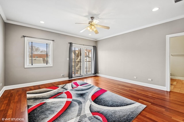 bedroom featuring crown molding, wood finished floors, and baseboards