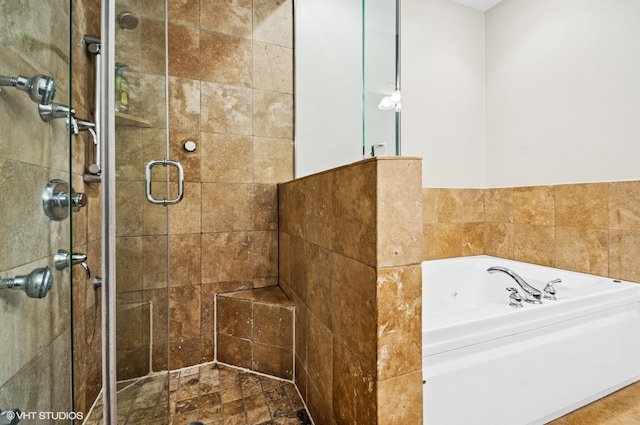 bathroom with a garden tub and a shower stall