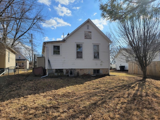 back of house with a yard and fence