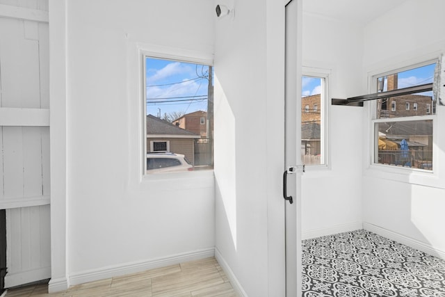 doorway to outside with baseboards