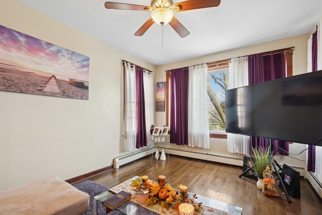 interior space with a ceiling fan, wood finished floors, baseboards, and a baseboard radiator