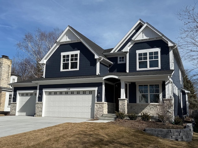 craftsman inspired home featuring stone siding, concrete driveway, and a garage