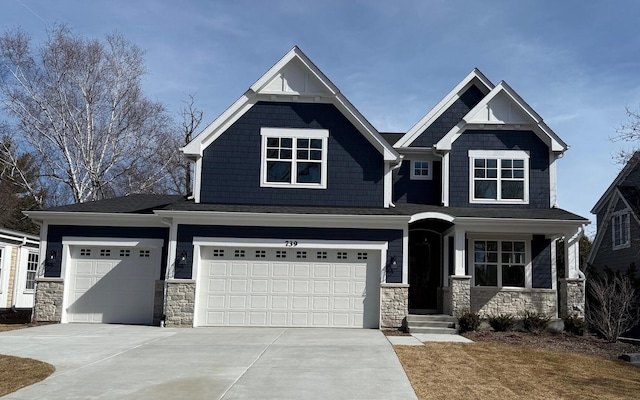 craftsman house featuring stone siding, concrete driveway, and a garage