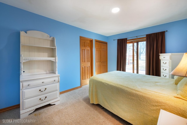 bedroom with light carpet and baseboards