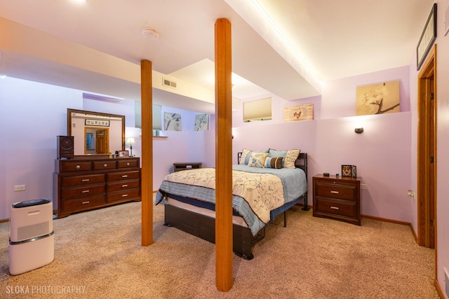 carpeted bedroom featuring baseboards and visible vents