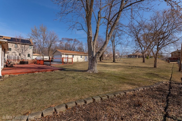 view of yard with a deck and an outdoor structure