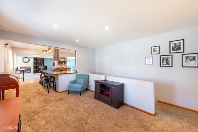 sitting room with recessed lighting, baseboards, and light carpet