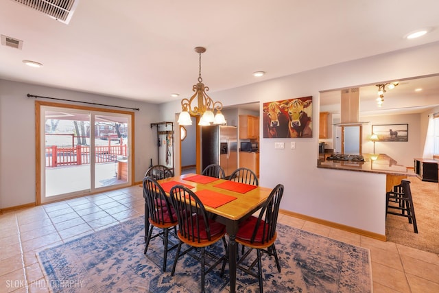 dining area featuring a notable chandelier, baseboards, and visible vents