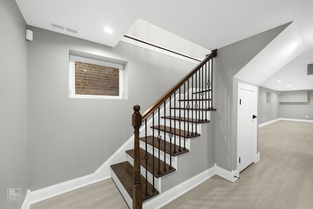 stairway with recessed lighting, wood finished floors, visible vents, and baseboards