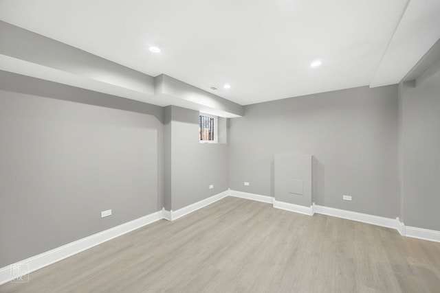 below grade area featuring light wood-type flooring, visible vents, baseboards, and recessed lighting