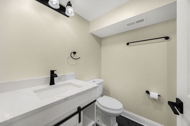 half bath with toilet, vanity, visible vents, and baseboards