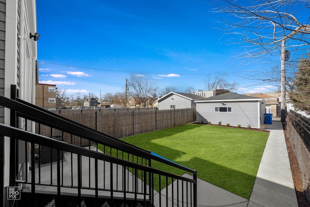 view of yard featuring a fenced backyard and an outdoor structure