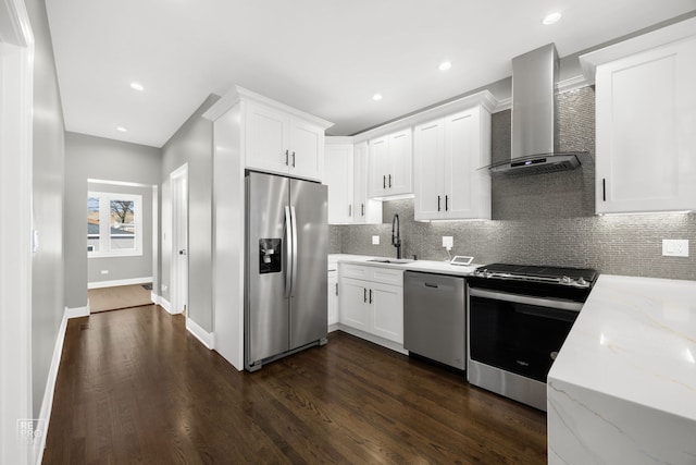 kitchen with dark wood-style flooring, stainless steel appliances, tasteful backsplash, a sink, and wall chimney range hood