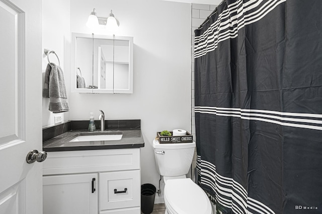 bathroom featuring toilet and vanity