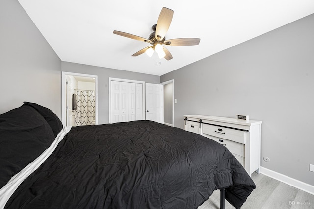 bedroom with baseboards, connected bathroom, ceiling fan, light wood-style floors, and a closet