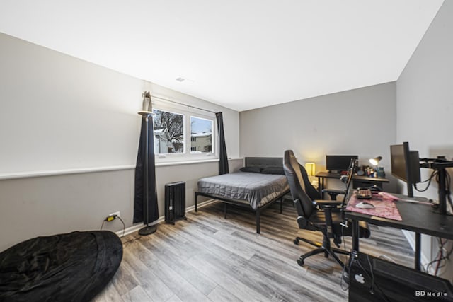 bedroom featuring wood finished floors and baseboards