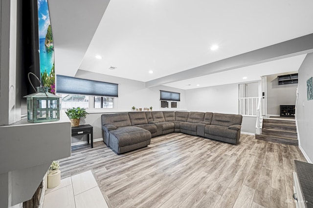 living area featuring stairway, wood finished floors, visible vents, and recessed lighting