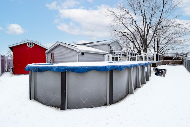 snow covered pool featuring a covered pool