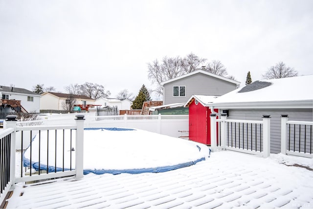 snow covered patio with fence