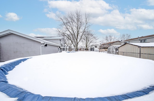 yard covered in snow with fence