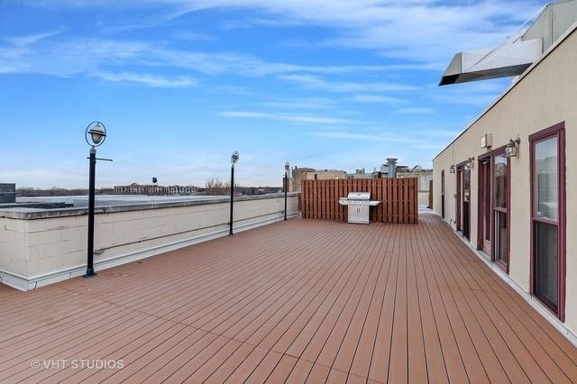 wooden deck with a grill