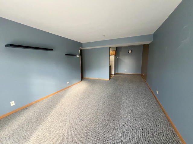 unfurnished room with carpet floors and baseboards