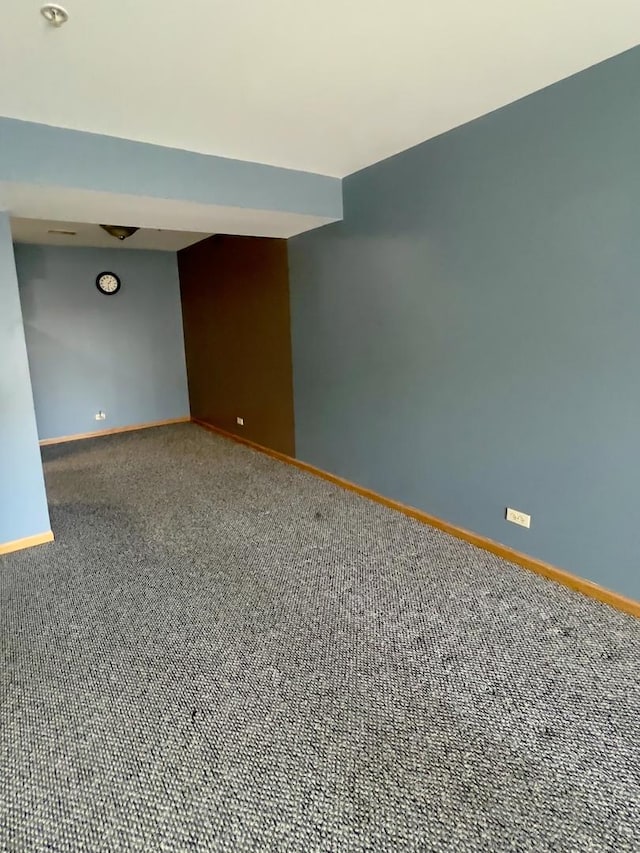 empty room with carpet floors and baseboards