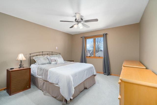 bedroom with baseboards, light carpet, and ceiling fan