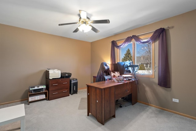 office space featuring light colored carpet, baseboards, and ceiling fan