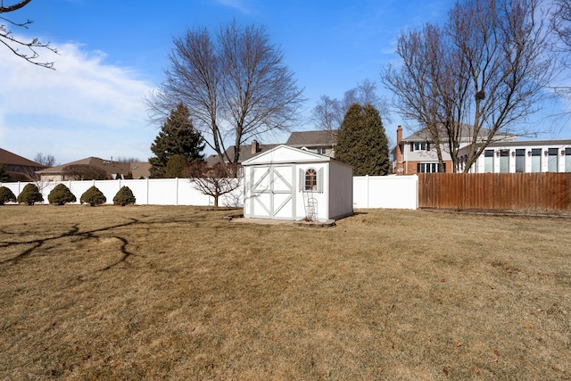 view of yard featuring a fenced backyard, a storage shed, and an outdoor structure