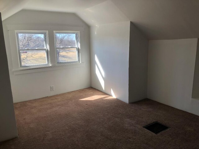 bonus room with lofted ceiling, carpet, and visible vents