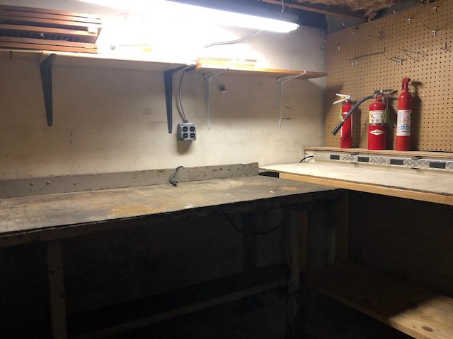 unfinished basement featuring a workshop area