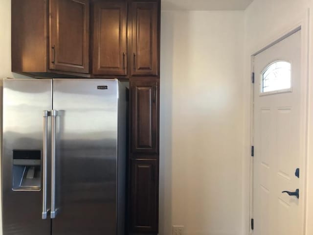 kitchen with dark brown cabinetry and high end refrigerator