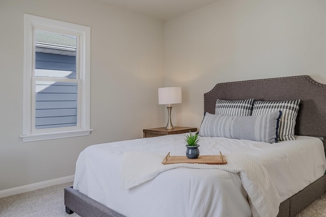 bedroom featuring carpet floors, multiple windows, and baseboards