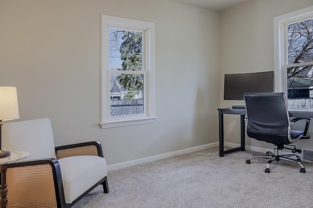 carpeted office featuring visible vents and baseboards