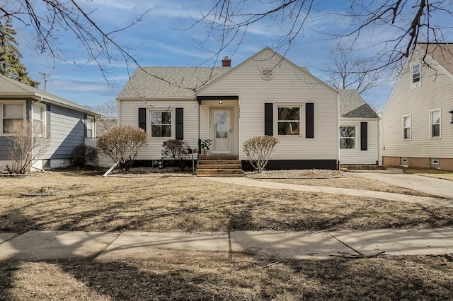 bungalow-style home featuring a shingled roof and a chimney