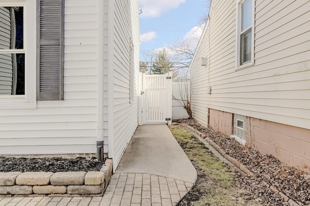 view of property exterior with a gate and fence