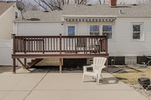 back of property featuring a patio, a shingled roof, and a chimney