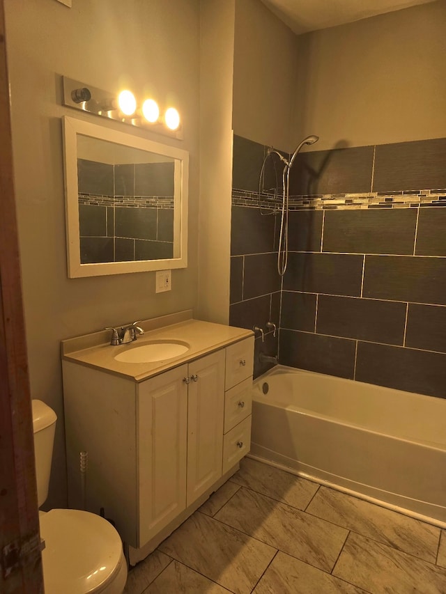 full bathroom featuring toilet, washtub / shower combination, and vanity