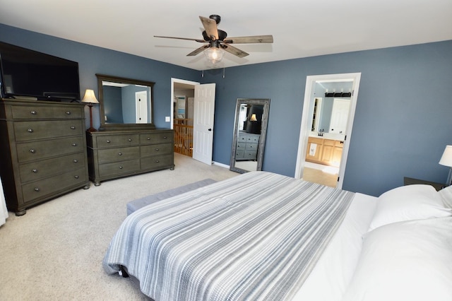 bedroom with carpet flooring, ceiling fan, and ensuite bath