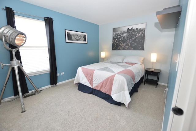 carpeted bedroom featuring multiple windows and baseboards