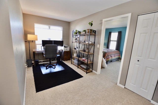 home office with a healthy amount of sunlight, baseboards, and carpet floors