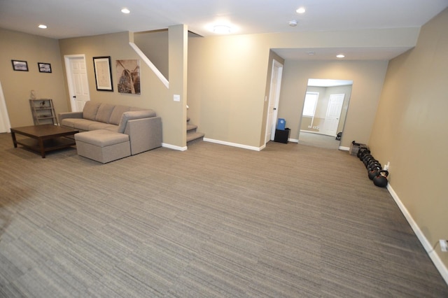 unfurnished living room featuring carpet, baseboards, stairway, and recessed lighting