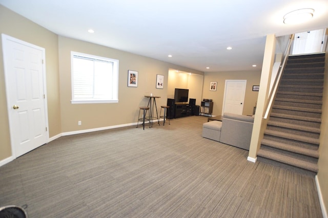 carpeted living room with baseboards, stairway, and recessed lighting