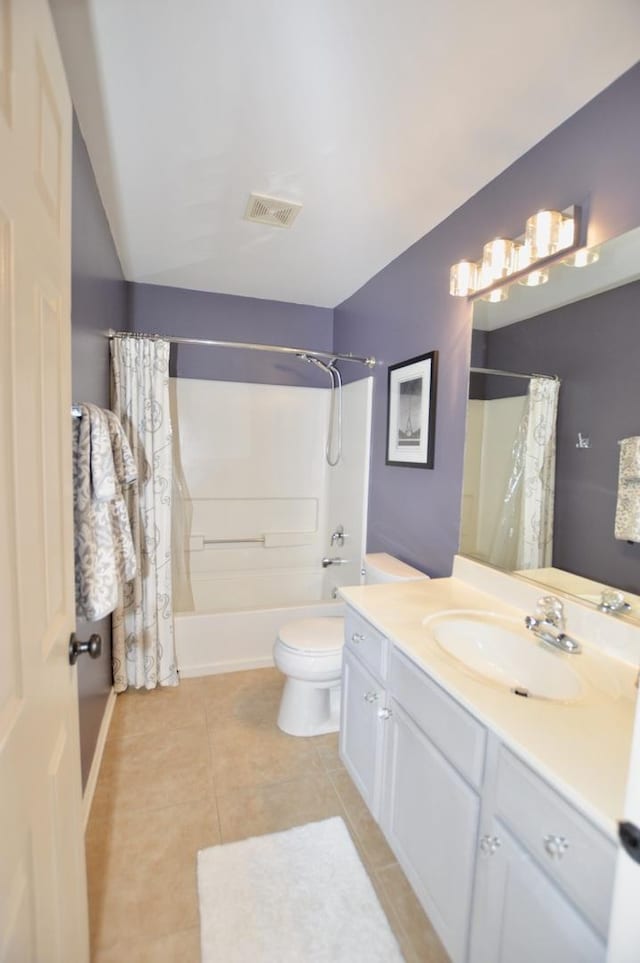 bathroom with toilet, vanity, visible vents, tile patterned floors, and shower / bath combo with shower curtain