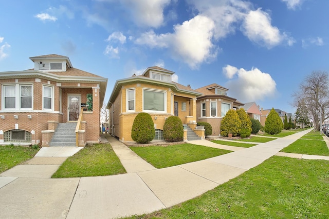 bungalow with brick siding and a front yard