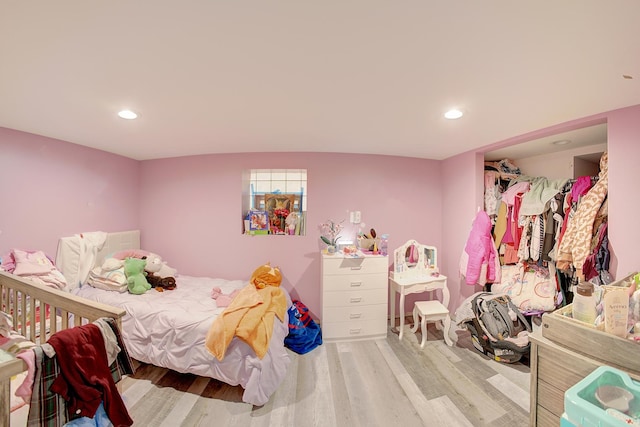 bedroom featuring recessed lighting and wood finished floors