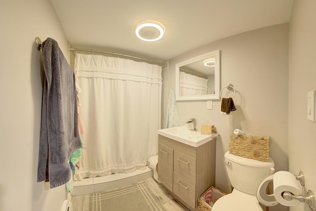 bathroom with toilet, vanity, and a shower with curtain