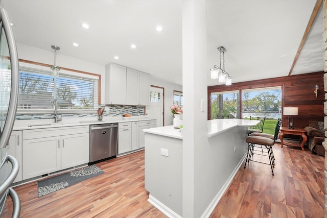 kitchen featuring appliances with stainless steel finishes, healthy amount of natural light, light countertops, light wood-style floors, and recessed lighting